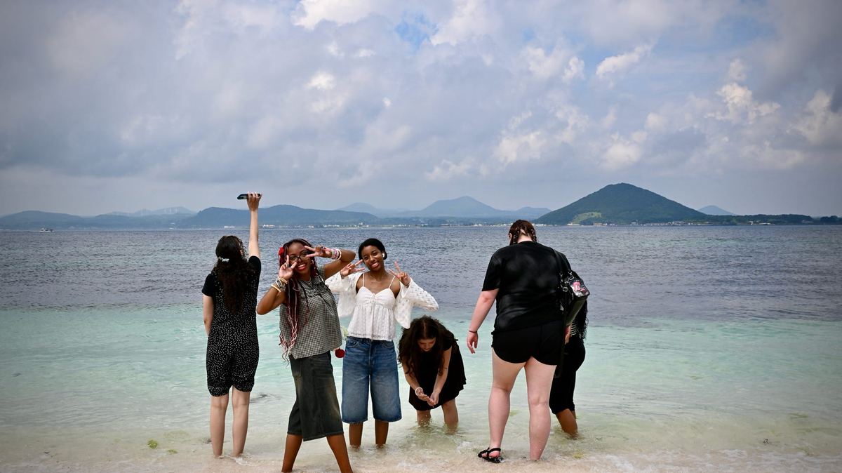 Students standing in shallow water off Udo, Jeju