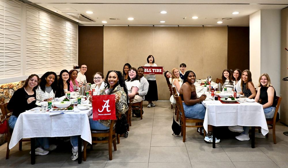 The group around a long table at a Korean dinner